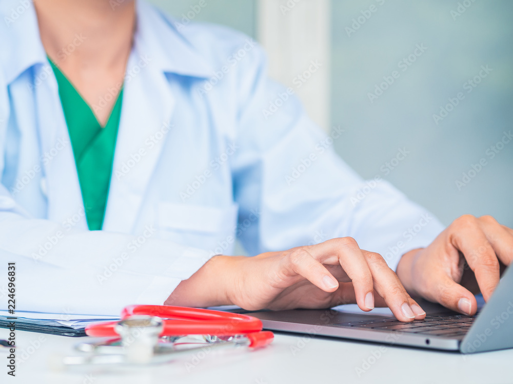 Doctor working with laptop computer in her office. Health care and medical Concept. Doctor working with laptop computer in her office. Health care and medical Concept.