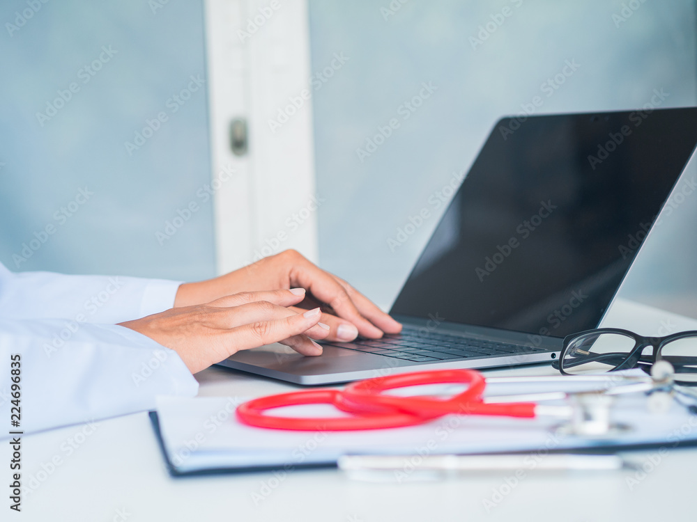 Doctor working with laptop computer in her office. Health care and medical Concept. Doctor working with laptop computer in her office. Health care and medical Concept.