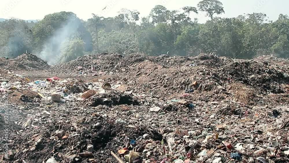 Large garbage dump waste with smoke Large garbage dump waste with smoke