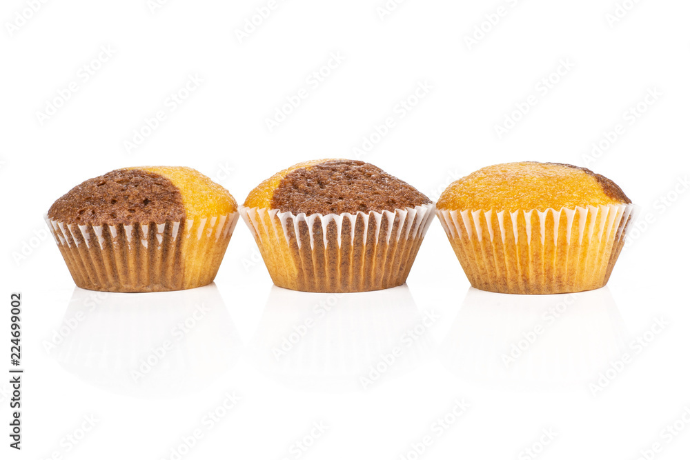 Group of three whole fresh baked marble muffin in row isolated on white background Group of three whole fresh baked marble muffin in row isolated on white background