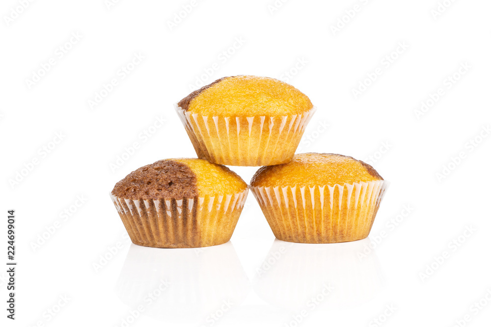 Group of three whole sweet fresh baked marble muffin isolated on white background Group of three whole sweet fresh baked marble muffin isolated on white background