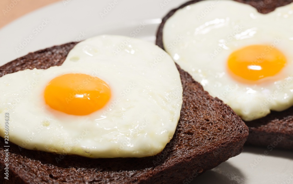 Two Slices of Bread with Fried Eggs in the Shape of Heart on the Two Slices of Bread with Fried Eggs in the Shape of Heart on the