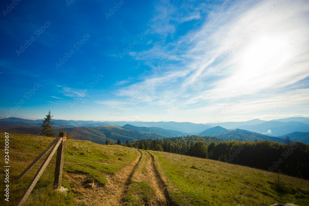 Beautiful landscape of summer mountains with blue sky. Autumn mountain village panoramic landscape