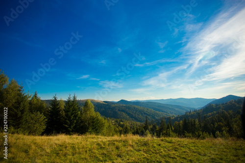 Beautiful landscape of summer mountains with blue sky. Autumn mountain village panoramic landscape © Svetlana