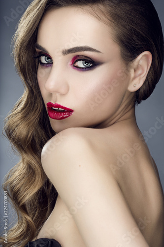 beautiful young woman with long brunette hair. Studio portrait. Cosmetology, cosmetics and make-up.