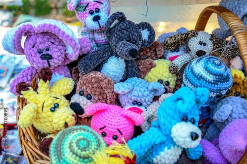 Knitted colorful toys of different animals in a street souvenir shop. © Valemaxxx