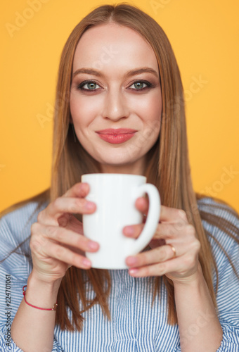 Charming content woman with cup of coffee