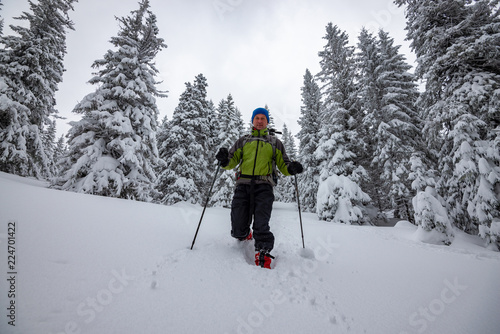 Smiling adventurer is walking snowshoeing © sanechka