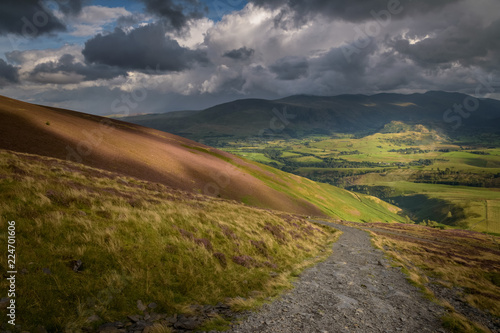 Hiking to the top of skiddaw mountain Lake District England view on Keswick valley with beautiful sunlight