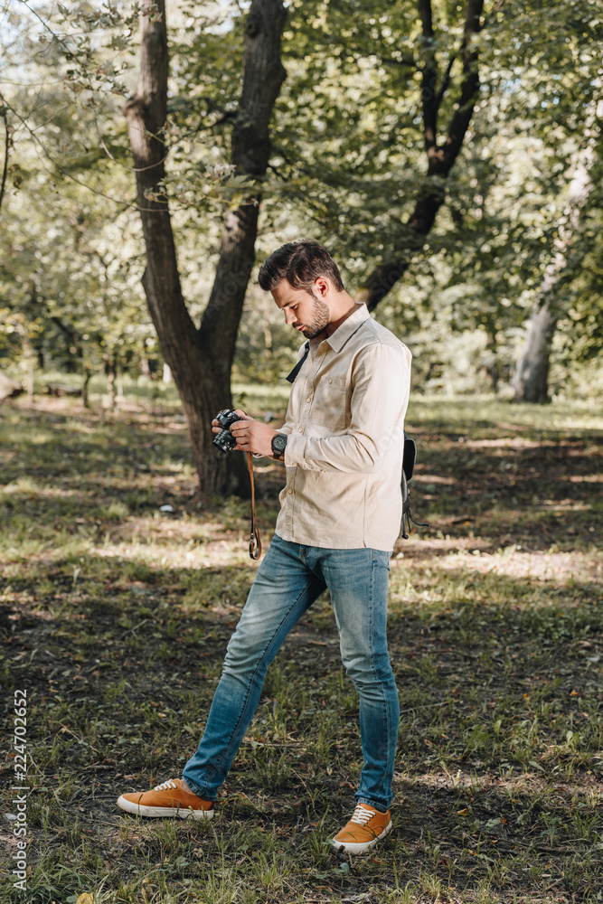 traveler with photo camera walking in park traveler with photo camera walking in park