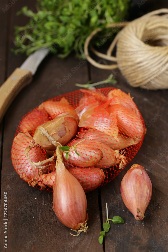 organic shallots on a wooden table, rustic style - obrazy, fototapety, plakaty 
