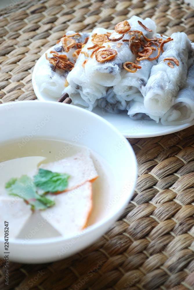 Banh cuon-vietnamese steamed rice rolls with minced meat inside and pieces of vietnamese ham accompanied by bowl of fish sauce. Banh cuon-vietnamese steamed rice rolls with minced meat inside and pieces of vietnamese ham accompanied by bowl of fish sauce.