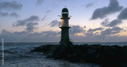 Lighthouse in Warnem ºnde at dawn photo