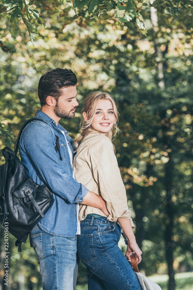 side view of romantic couple standing in autumn park