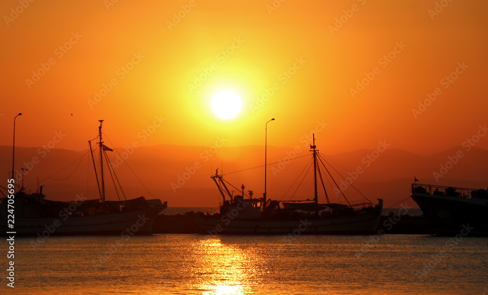 Sunset at sea. Ships in the harbour. 