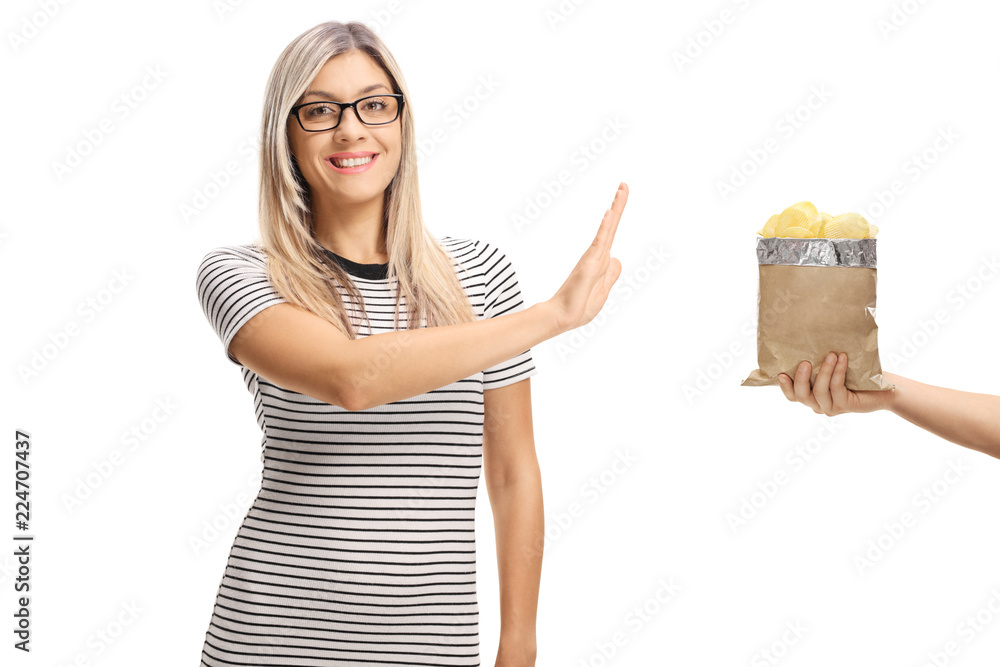 Obraz premium Young woman refusing a bag of potato chips