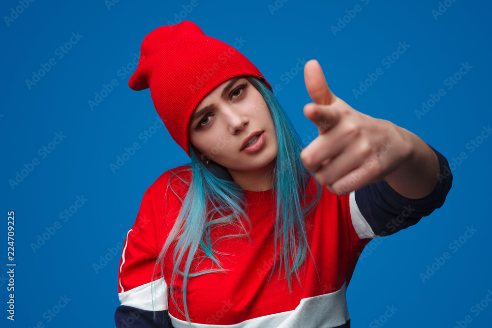 Frowning woman pointing at camera Frowning woman pointing at camera