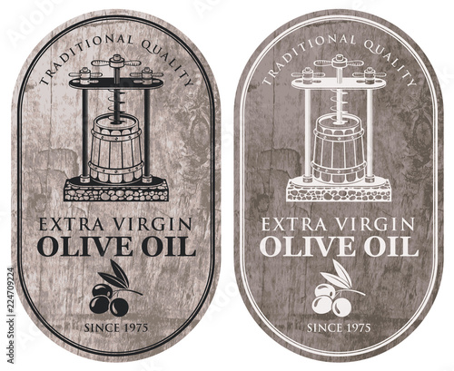 Set of vector labels for extra virgin olive oil with olive twig, oil press and barrel in retro style on wooden background