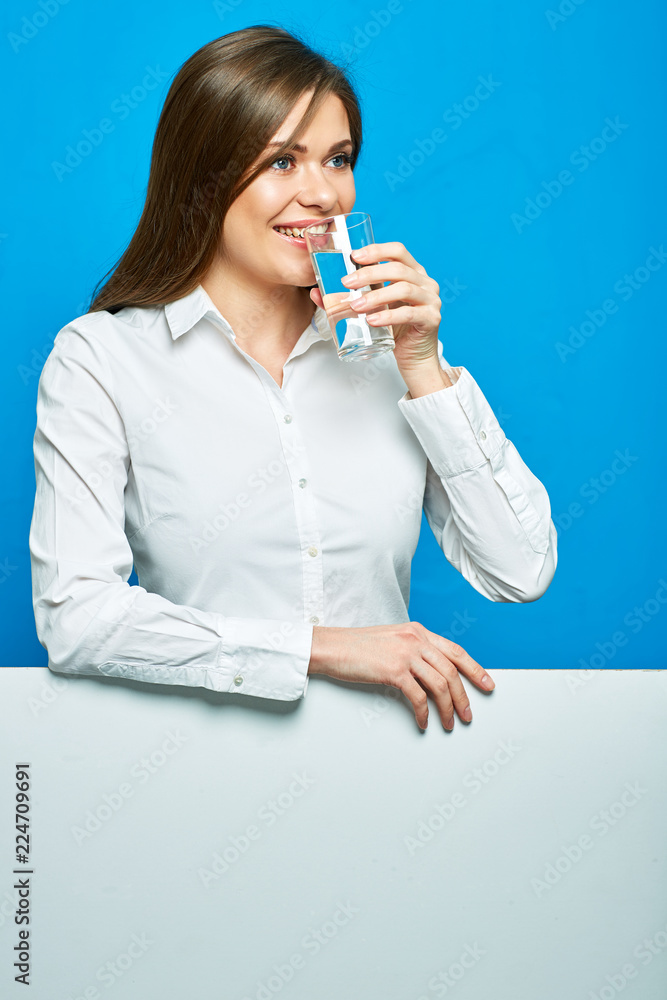 Smiling woman wearing white shirt drinking water. Smiling woman wearing white shirt drinking water.