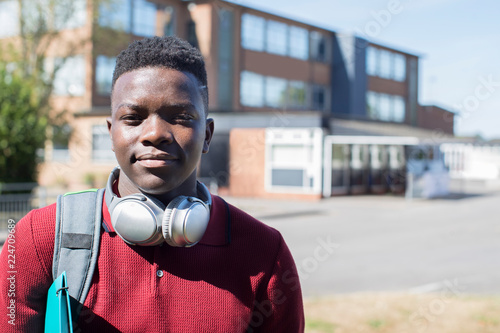 Portrait Of Male Teenage Student Outside College Building Wearing Wireless Headphones