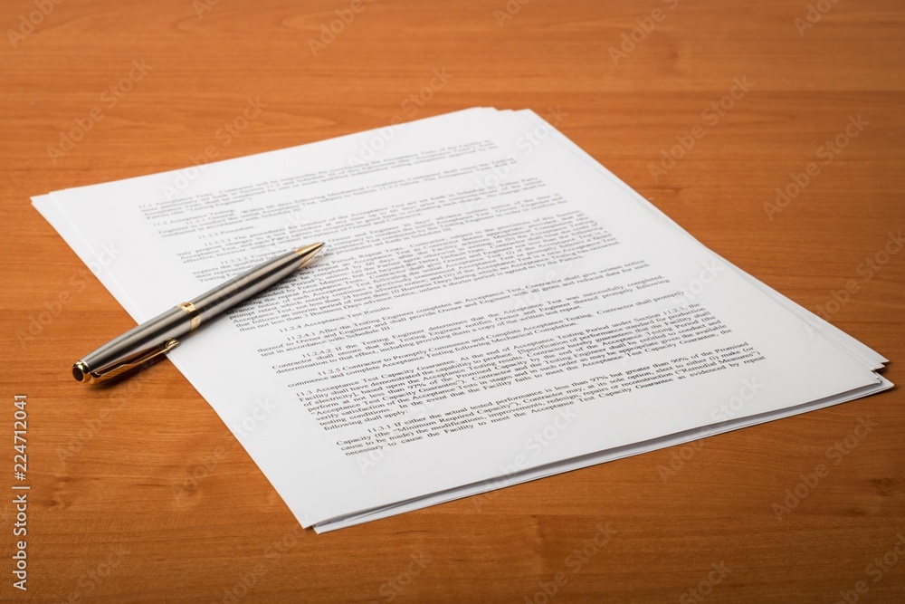 Pen on top of a contract Pen on top of a contract