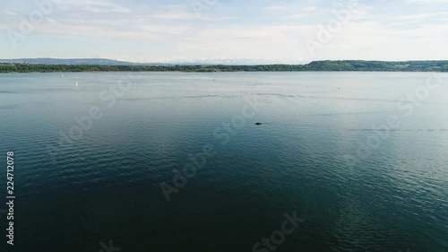 aerial view on blue lake with some boats snow mountains in distance, lake biel switzerland photo