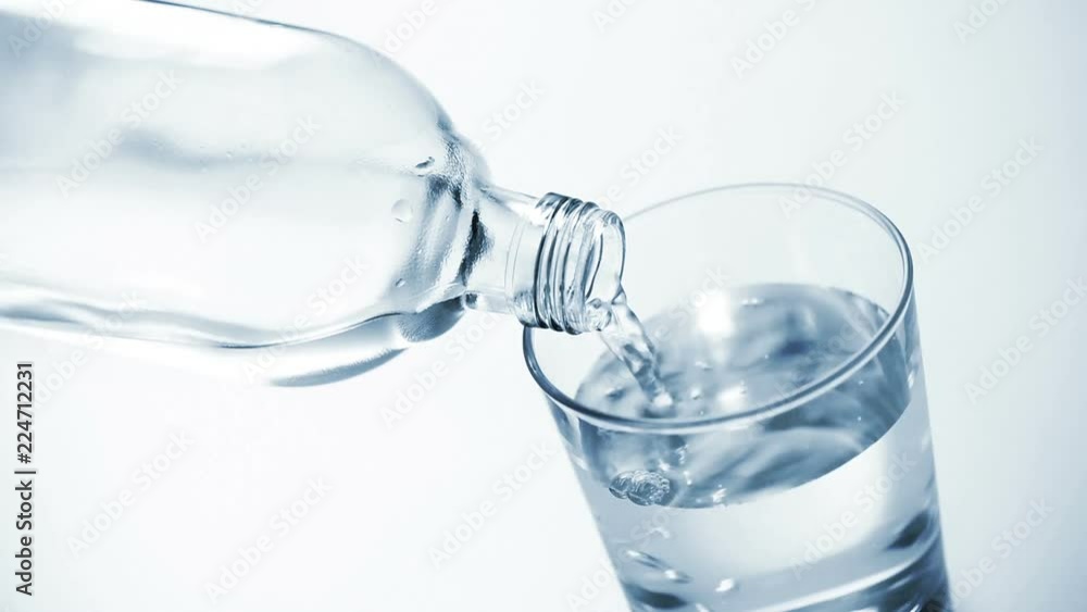 Looping cinemagraph, pouring clear water into glass on blue background Looping cinemagraph, pouring clear water into glass on blue background