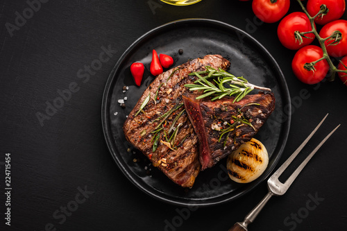 Delicious beef steak with salad  aromatic herbs  chery tomatoes