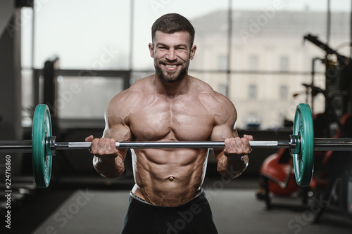 Brutal strong bodybuilder athletic men pumping up muscles with dumbbells