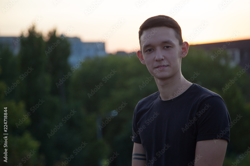 cute confident young boy standing outdoors at sunset sky cute confident young boy standing outdoors at sunset sky