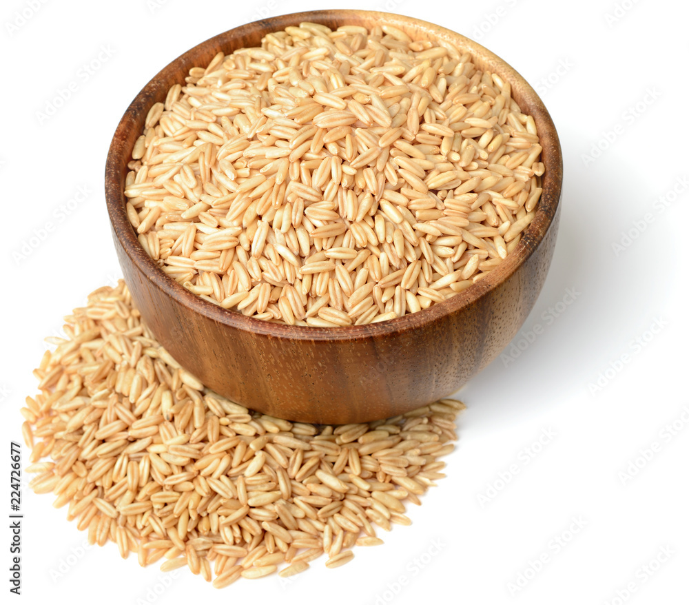 uncooked oats in the wooden bowl, isolated on white uncooked oats in the wooden bowl, isolated on white