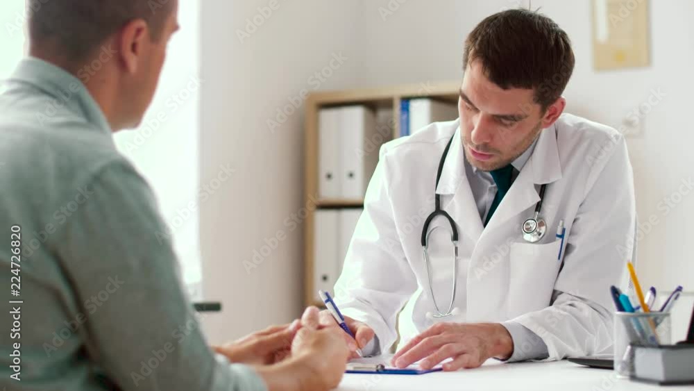 medicine, healthcare and people concept - doctor writing prescription for male patient at clinic medicine, healthcare and people concept - doctor writing prescription for male patient at clinic
