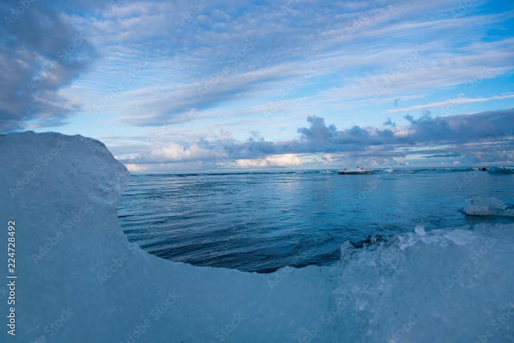 Ocean view framed by an iceberg on the shore of Iceland's Diamond Beach