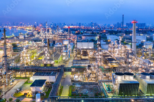 Industrial view at oil refinery plant form industry zone with sunrise and cloudy sky.Oil refinery and Petrochemical plant at dusk Thailand. Aerial view