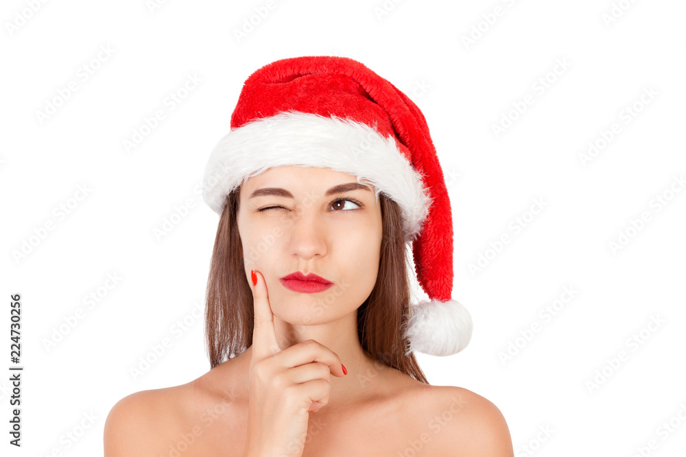 Girl in christmas hat dreaming about holidays. emotional woman in red santa claus hat isolated on white background. Happy Christmas and New Year holidays concept Girl in christmas hat dreaming about holidays. emotional woman in red santa claus hat isolated on white background. Happy Christmas and New Year holidays concept