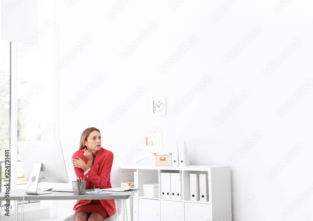 Young woman freezing under air conditioner in office Young woman freezing under air conditioner in office