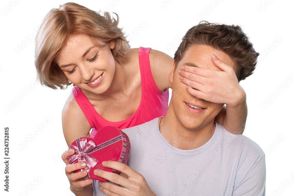 Portrait of Woman Holding a Gift and Covering Boyfriend's Eyes Portrait of Woman Holding a Gift and Covering Boyfriend's Eyes