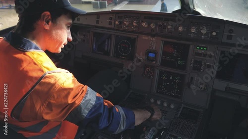 Engineer checks the equipment in the cockpit of a passenger aircraft. 4k.