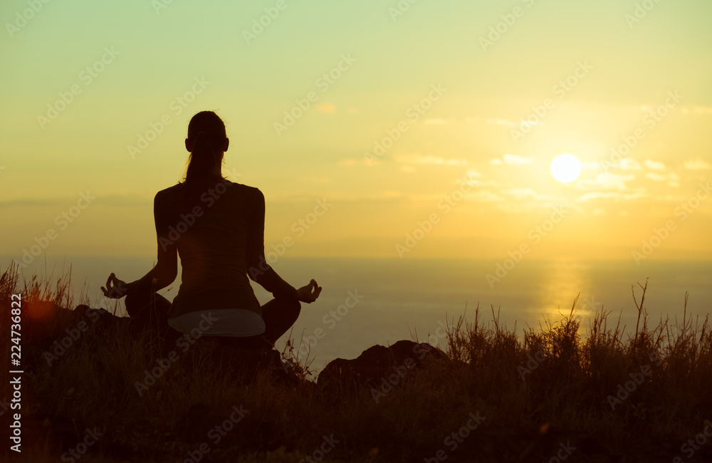 Woman meditating outdoors. Personal reflection and meditation. 
