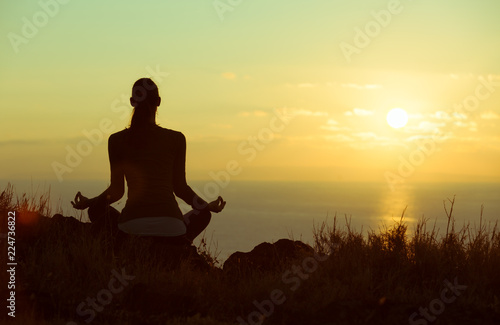 Woman meditating outdoors. Personal reflection and meditation. 
