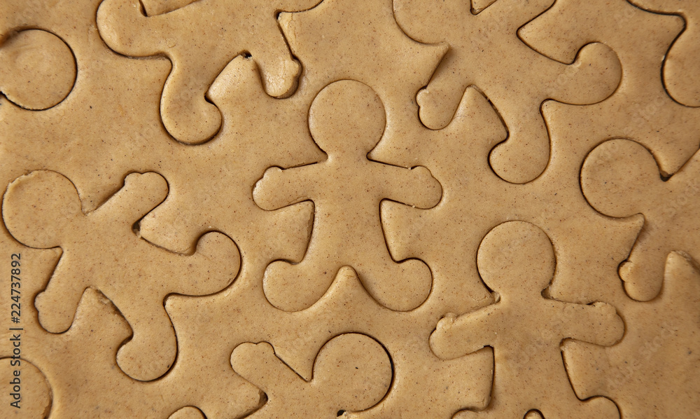 Raw Gingerbread Cookie Dough Being Cut into Gingerbread People