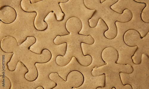 Raw Gingerbread Cookie Dough Being Cut into Gingerbread People photo