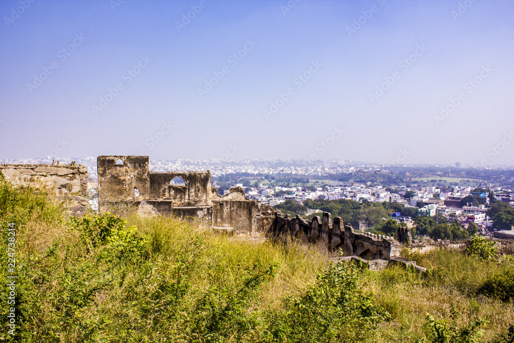 Ruins of a Fortress Wall with the Old City Skyline in the Background at Golconda Fort in Hyderabad, India