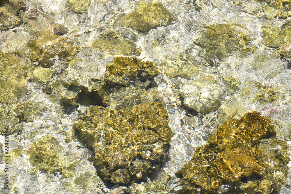 Crystal clear water from the indian ocean in the Maldives, lapping over rocks. Crystal clear water from the indian ocean in the Maldives, lapping over rocks.