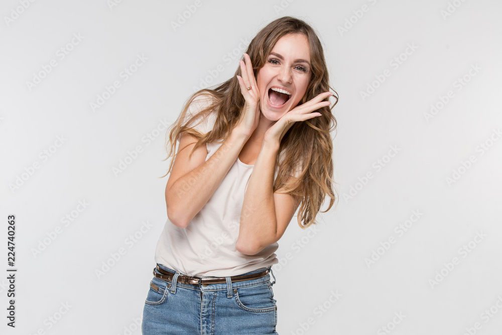 Wow. Beautiful female half-length front portrait isolated on studio backgroud. Young emotional surprised woman standing with open mouth. Human emotions, facial expression concept. Trendy colors Wow. Beautiful female half-length front portrait isolated on studio backgroud. Young emotional surprised woman standing with open mouth. Human emotions, facial expression concept. Trendy colors