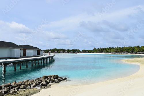 Overwater Bungalows and villas, over crystal clear blue ocean, on a tropical island in the Maldives © N Roberts
