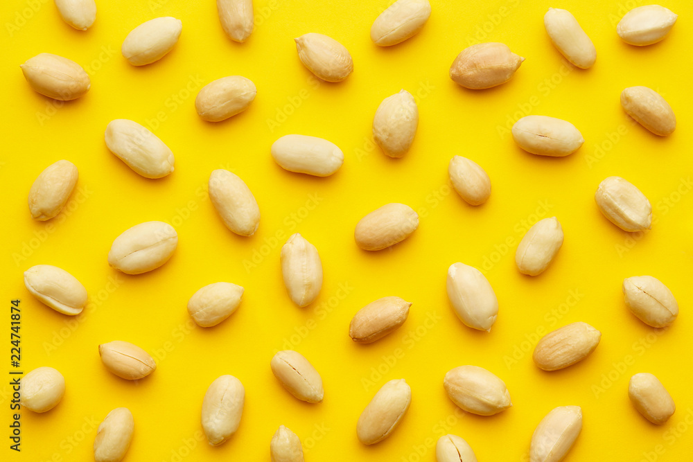 Peanuts pattern isolated on a yellow backround. Repetition concept. Top view Peanuts pattern isolated on a yellow backround. Repetition concept. Top view