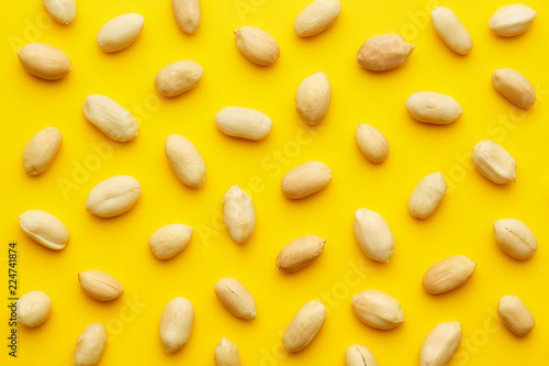 Peanuts pattern isolated on a yellow backround. Repetition concept. Top view