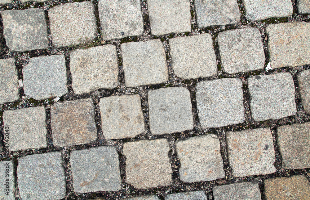 old style cobblestone pavement of grey granite stones old style cobblestone pavement of grey granite stones
