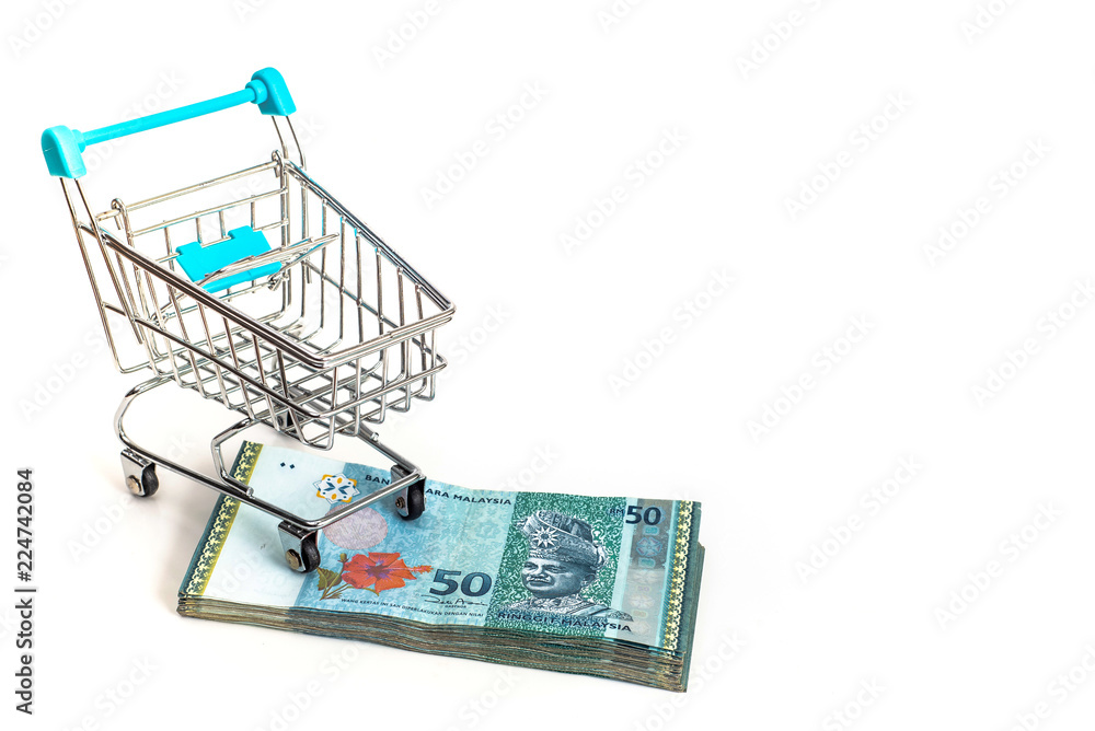 A shopping cart on the stacked Malaysian Ringgit, isolated on white background.